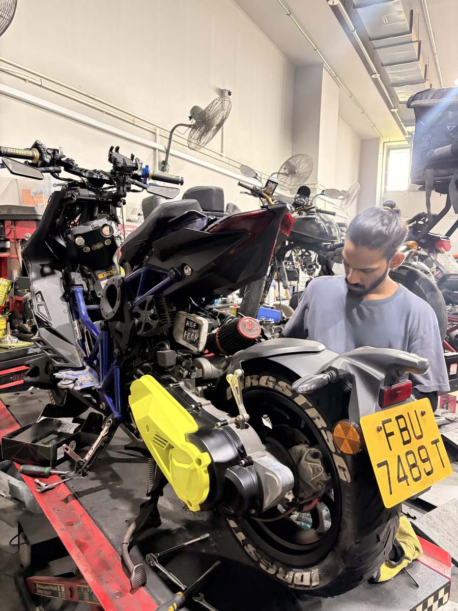 Mechanic working on an Italjet Dragster at Scooter Narcotics